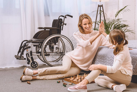 残疾母亲和女儿在下象棋图片