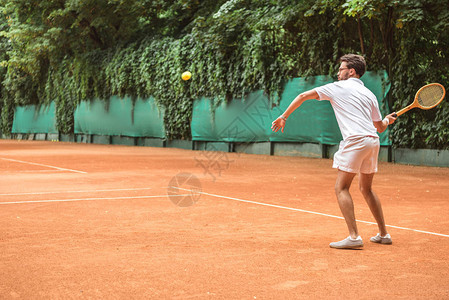 老式运动员在网球场上用球图片