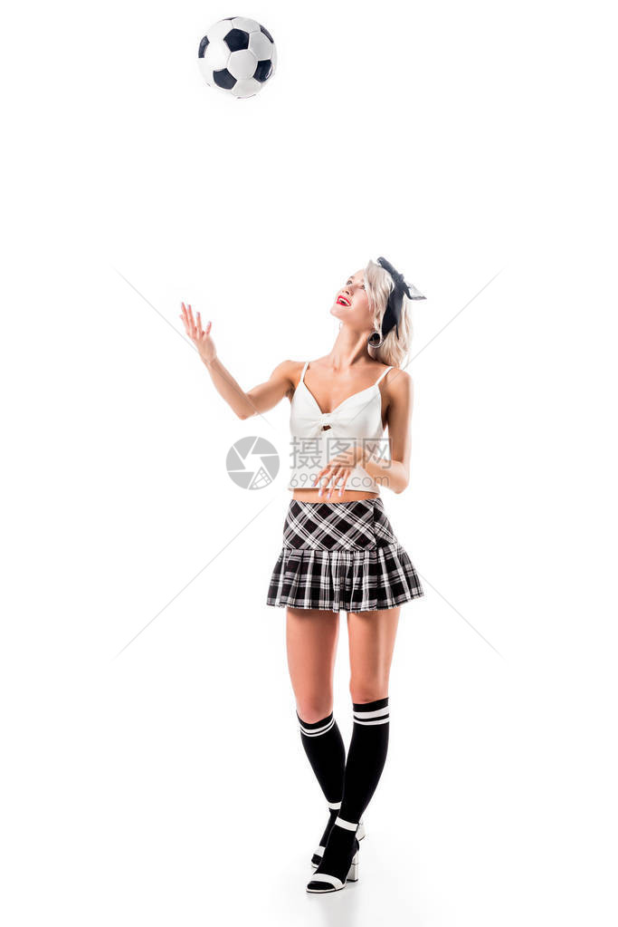 穿着感格丽女学生裙子的年轻女子扔足球图片
