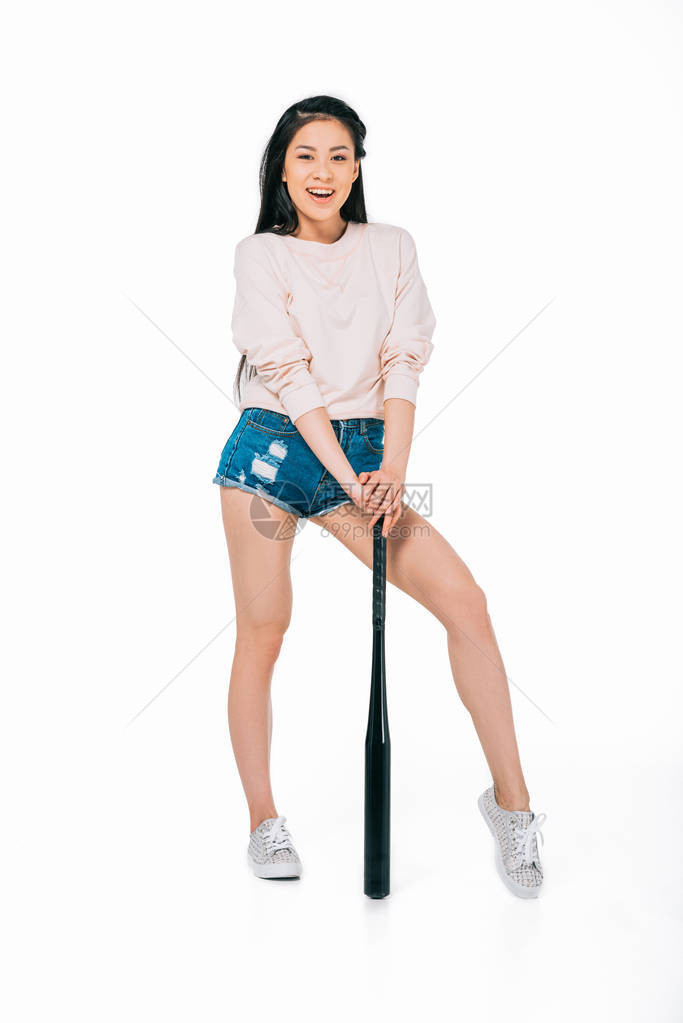 美丽的美丽微笑的年轻亚洲女人假扮着棒球图片