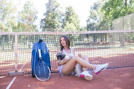 美丽的年轻女子在网球赛后在图片