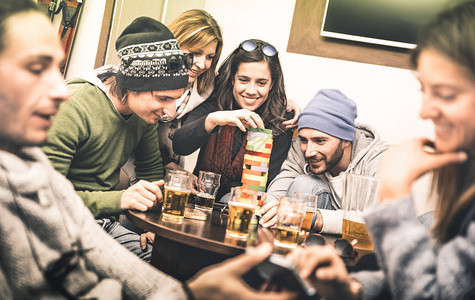 快乐的朋友在酒吧喝啤酒时玩桌游图片