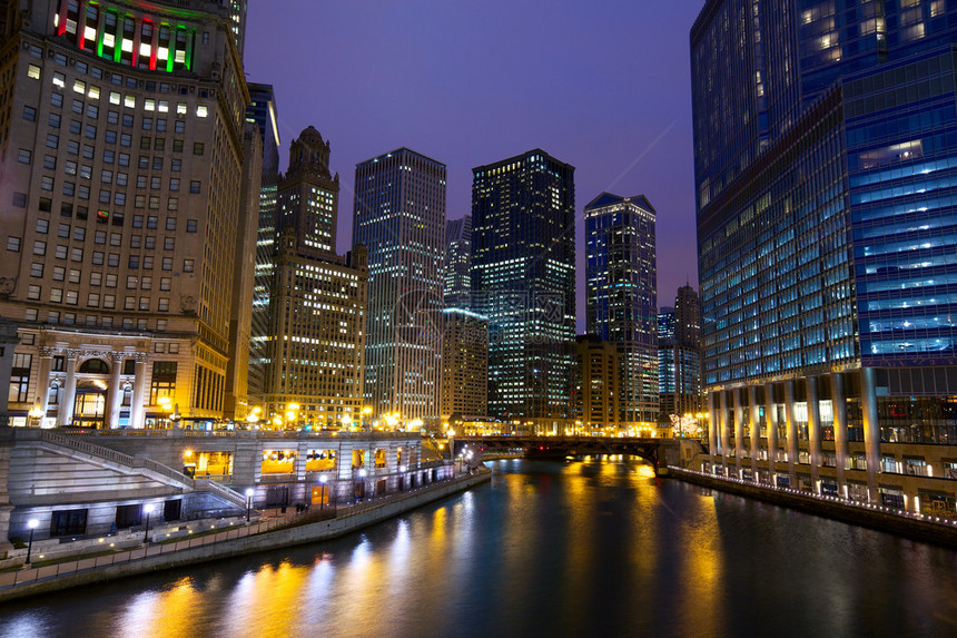 芝加哥河漫步与城市摩天大楼和夜间水倒图片