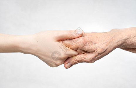 用手握着老手来帮助老人的概念给年背景图片