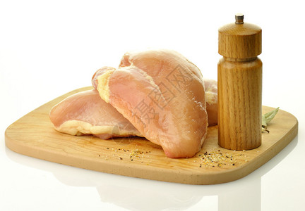 木砧板上的生鸡胸肉图片