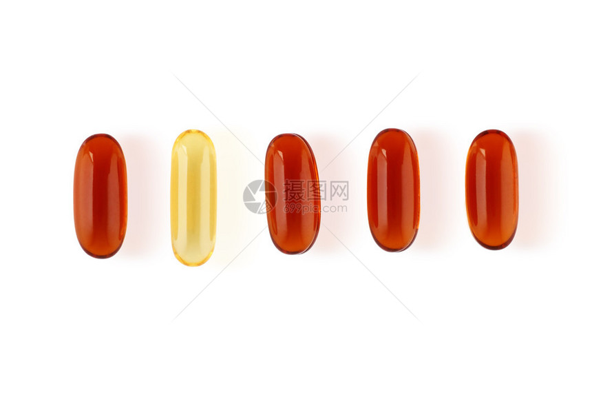 一连串橙色药丸中的单一黄药片图片