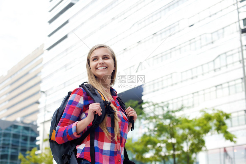 一个微笑着的女大学生带着袋图片