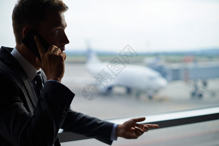 认真的商人在机场用手机交谈在机场使用图片