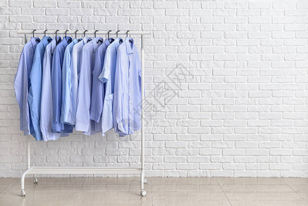 白砖墙附近干洗后的衣服架图片