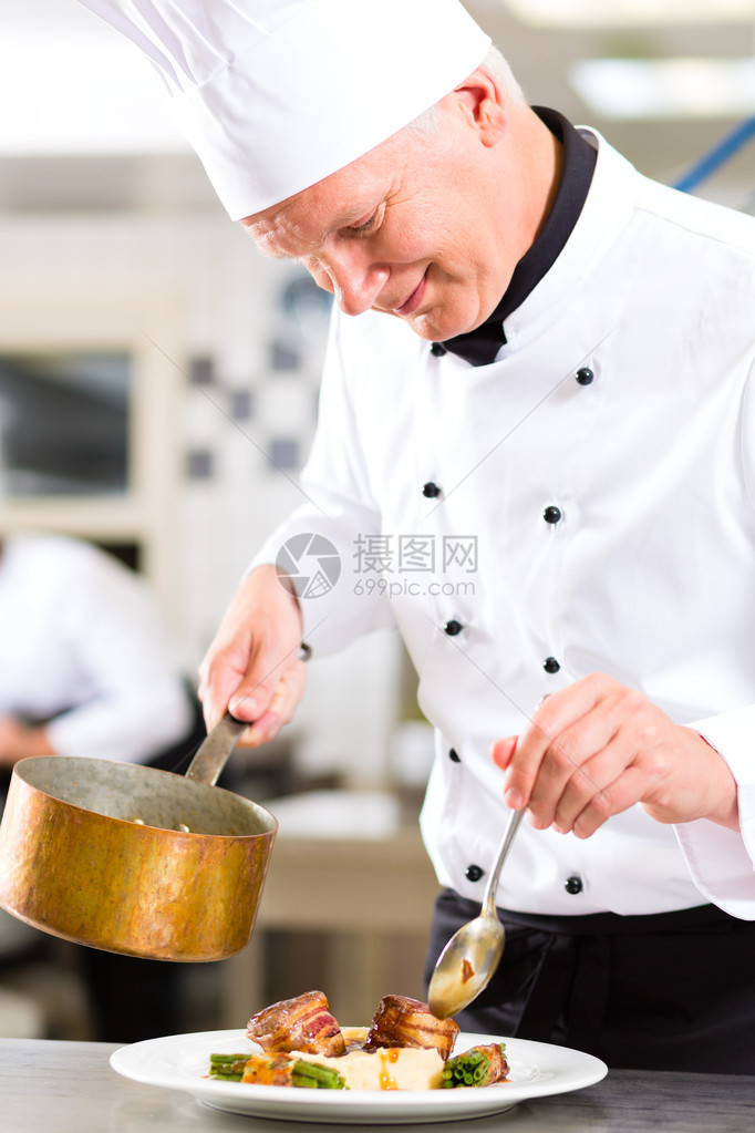 大厨在饭店或餐厅厨房烹饪图片