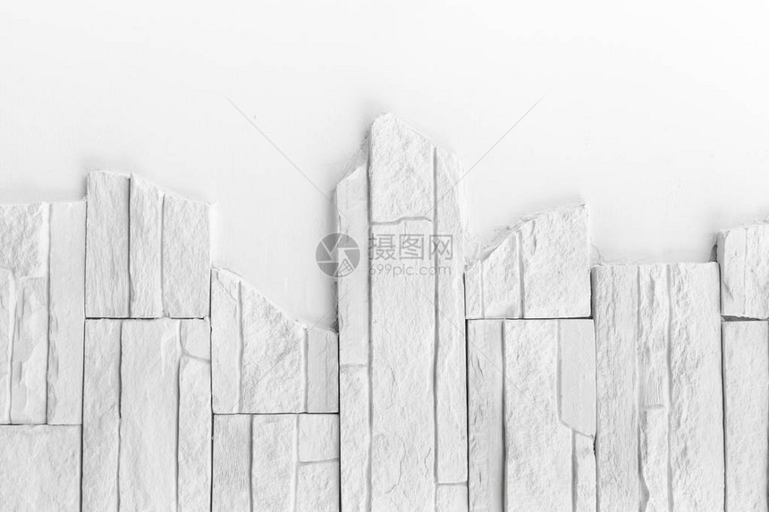 装饰白色板块石墙表面的图案模式背景或图片
