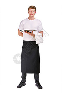 年青英俊的侍应服务员餐巾纸站图片