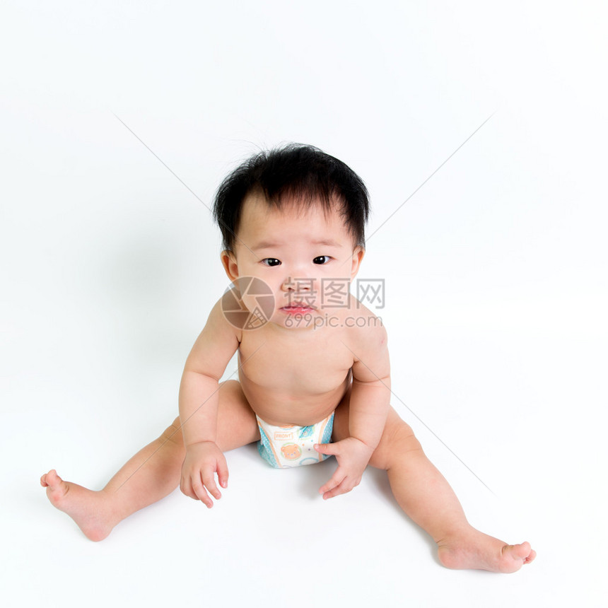 身着尿布的亚洲婴儿坐图片
