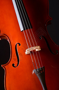 黑暗房间里的音乐大提琴背景图片