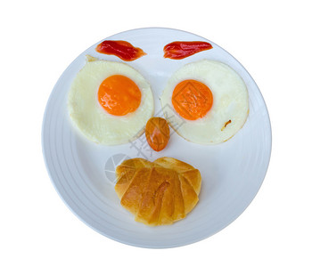 快乐的脸在鸡蛋早餐中被图片