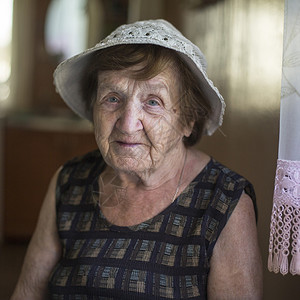 一位老妇人坐在她的房子里图片