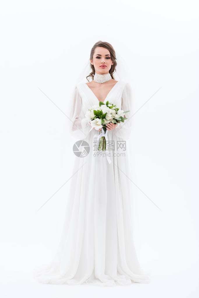 穿着传统礼服的优雅新娘拿着婚礼花图片