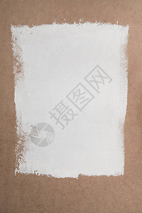 棕色胶合板表面上的白色油漆背景图片