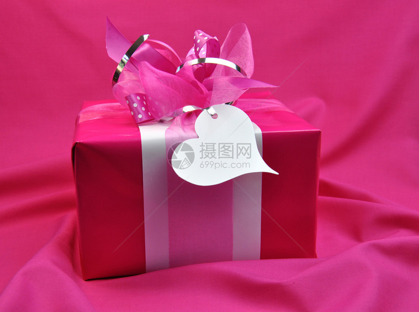 用丝带和白色礼品标签包装情人节圣诞节或生日礼物的热糖果粉红色礼物图片