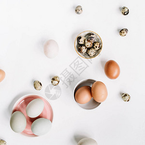 白色和棕色的复活节彩蛋和白色背景上的鹌鹑蛋图片