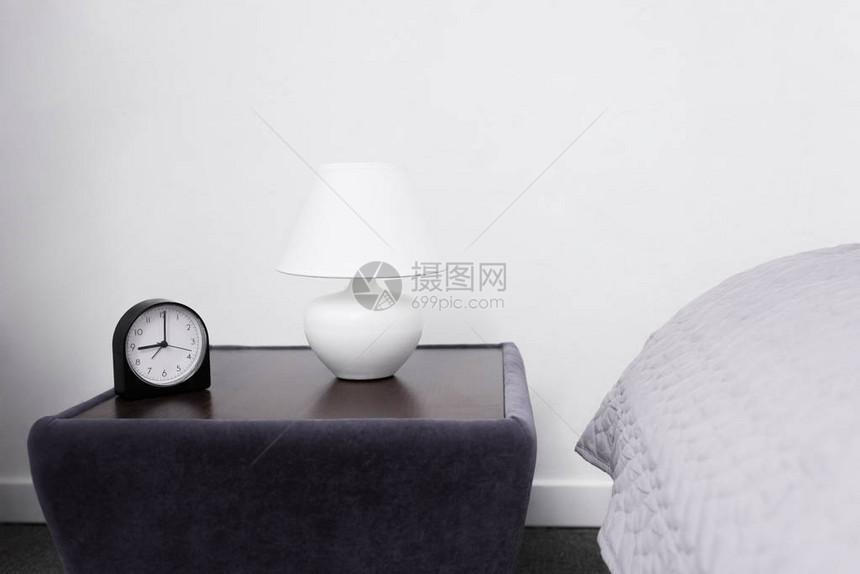 空荡的卧室配有带灯和闹钟的床头柜图片
