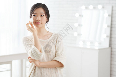 漂亮的韩国女孩用白海绵化妆的图片