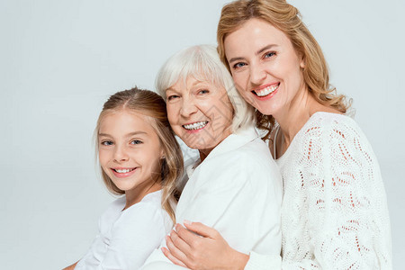 微笑的孙女母亲和祖母拥抱着被图片