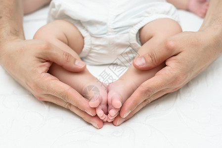 母亲用新生儿的双脚以心脏的形式抚育新生儿图片