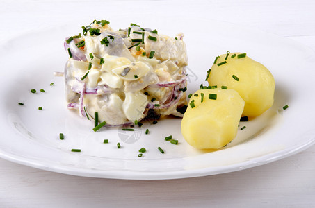 鲱鱼沙拉配丁香洋葱和茄克土豆背景图片