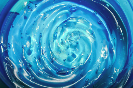 透明质酸美容凝胶蓝色背景上带有气泡的凝胶质地透明凝胶涂片特图片