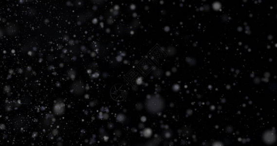黑色背景上的降雪背景图片