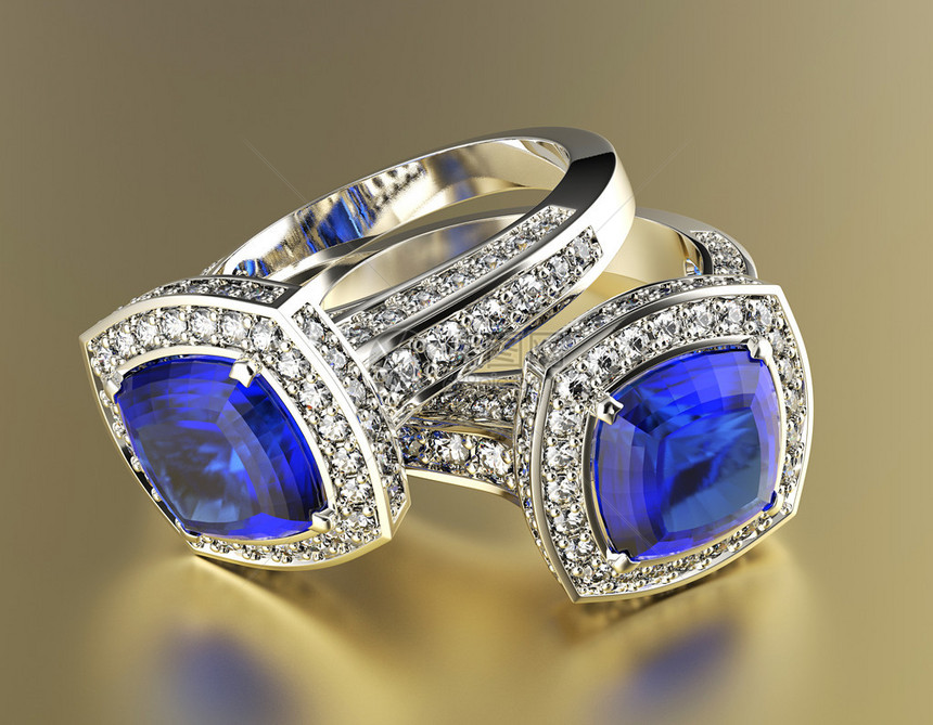 背景上镶有蓝色钻石的珠宝戒指图片