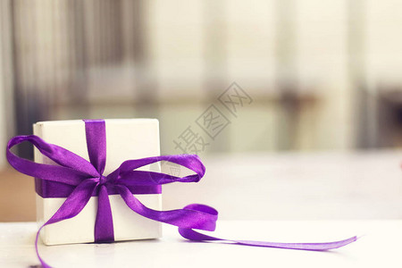 白色小礼物盒白木桌上图片