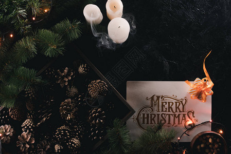 面板上戴着圣诞贺卡黑色桌顶上挂着圣誕贺卡的木盒子图片