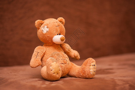 棕色泰迪熊坐在背景图片