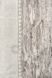 旧质朴的木质背景上带花边的亚麻织物图片