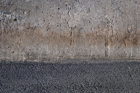 背景为粗糙的水泥墙和带砂砾的地板背景图片