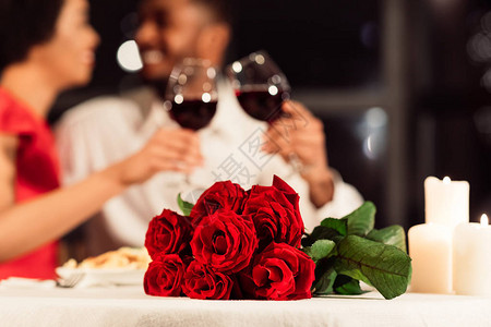 情人节浪漫约会红玫瑰躺在桌上无法辨认的配偶在餐馆饮酒有选择的图片