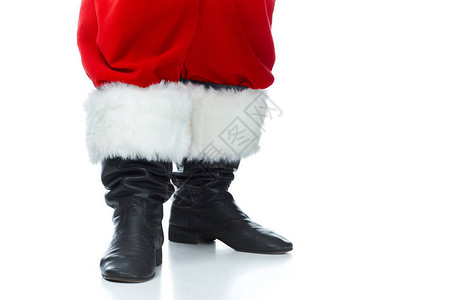 圣诞老人穿着被白色隔离的靴子摆姿势的剪影图片