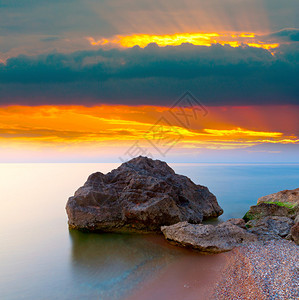 日落后海上的石头图片