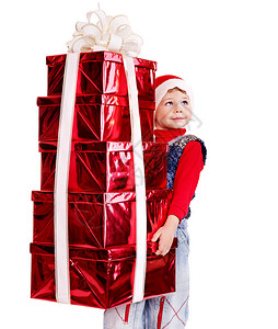 带着堆叠礼物盒的圣诞老人帽子的孩图片