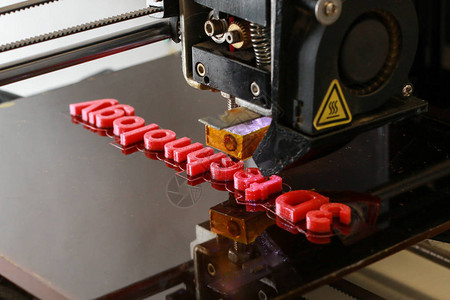 3D打印机将3D技术字词打印成红背景图片
