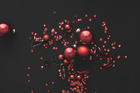 黑色背景中的红色圣诞球和五彩纸屑图片