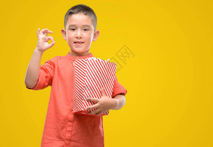 吃爆米花的黑头发小黑发小孩用手指做好标记图片