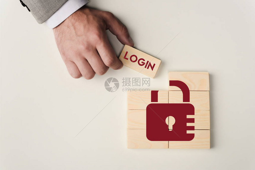 以白色隔离的锁图标在木块上用login字母表示的人持有砖图片