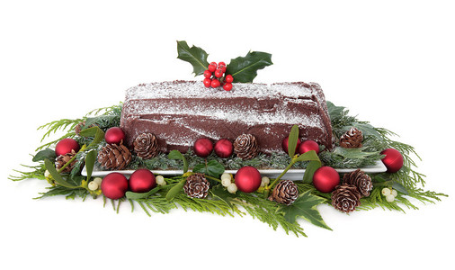 圣诞巧克力圆木蛋糕配有红酒杯装饰品和冬图片