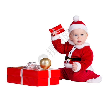 穿着圣诞老人服装的小男孩坐着图片