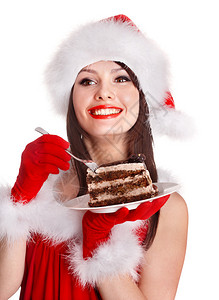 圣诞女孩穿着红圣塔帽吃蛋糕吃盘背景图片