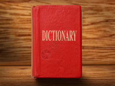 木制背景特写上的旧红色字典图片