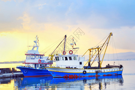 渔港日落下的渔船背景图片
